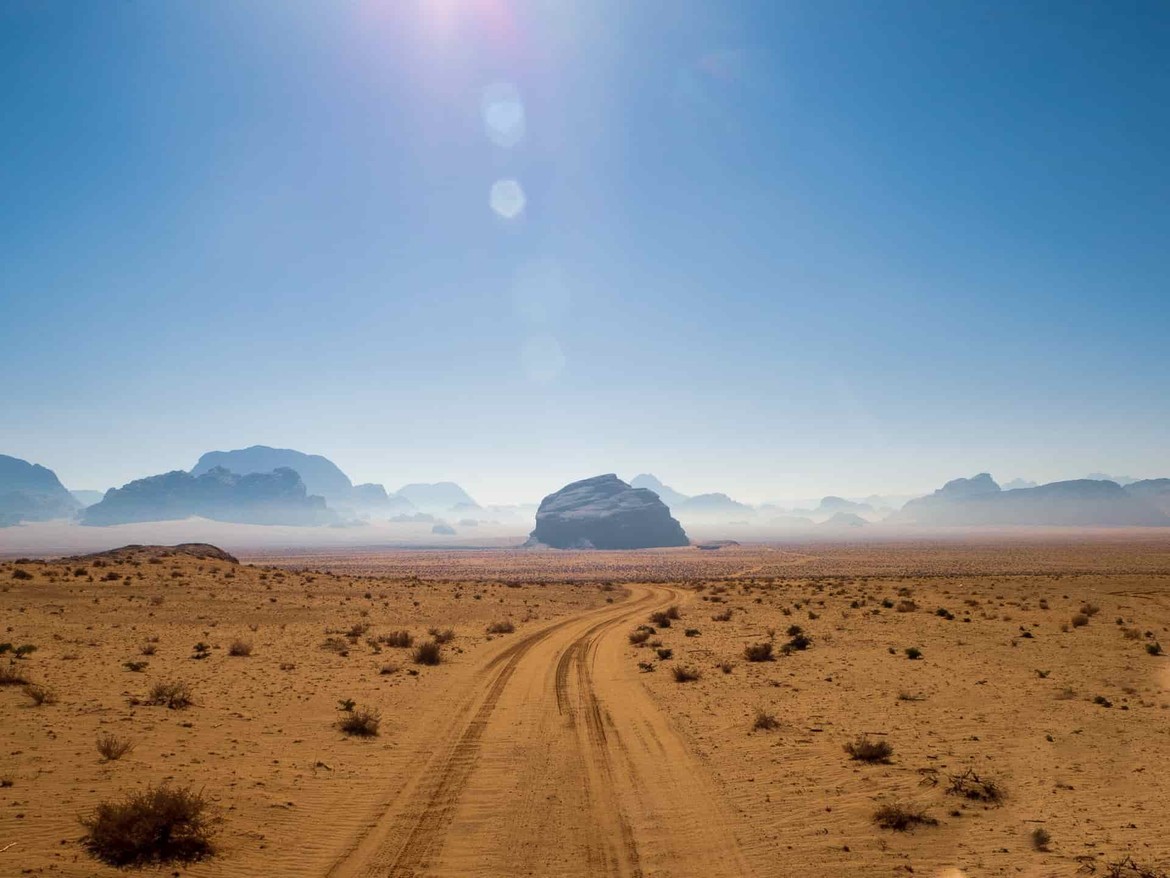 An empty desert with a road that has no signs of life
