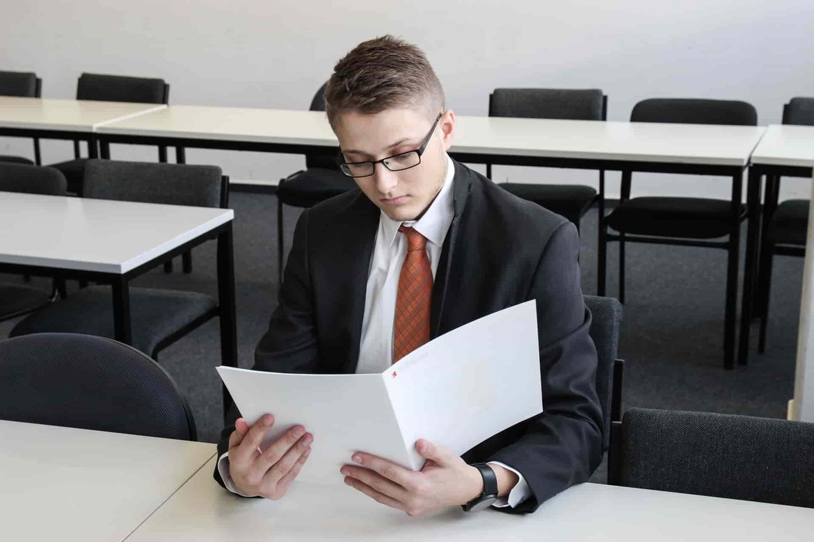 A man looking over a contract and not very happy