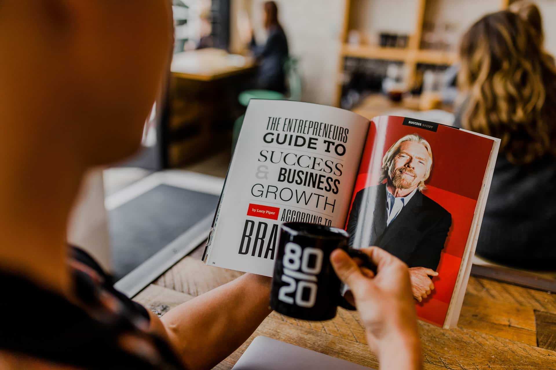 A man reading a business and entrepreneurship book.